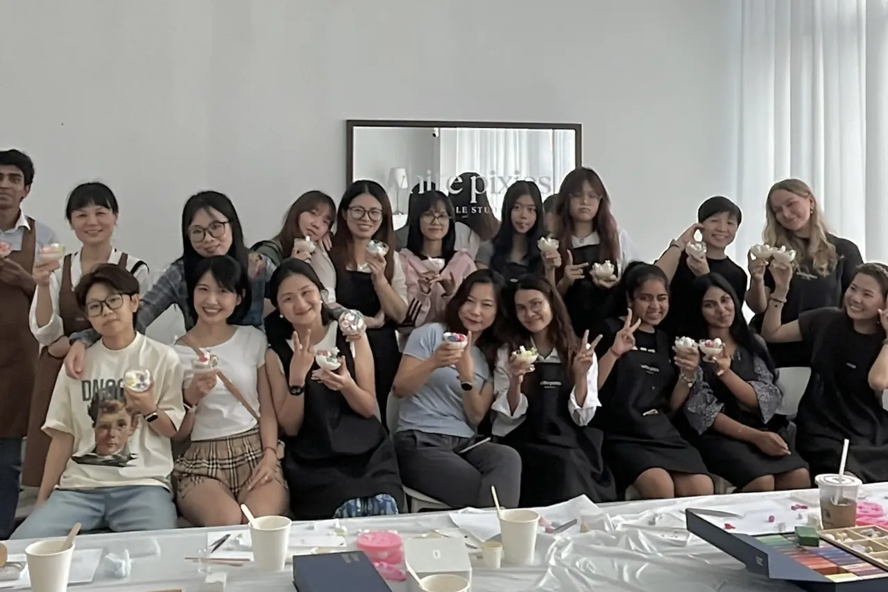 Friends making candles together at an indoor candle making workshop in Singapore