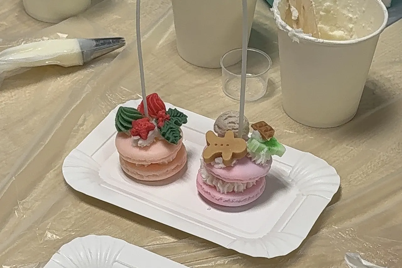 Piping cream wax into macaron candles