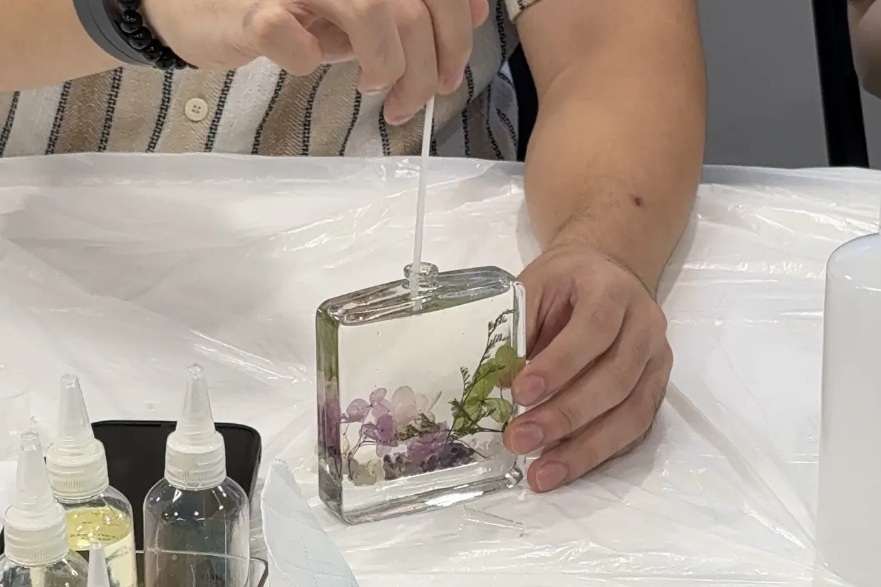 A finished botanical reed diffuser with dried flowers